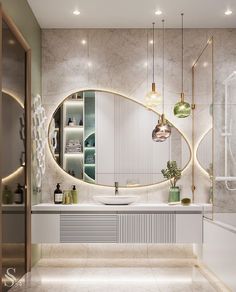 a bathroom with an oval mirror above the sink and lights hanging from the ceiling over it