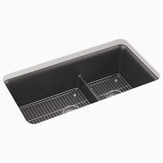 a black sink with two drainers and wire baskets on the bottom, in front of a white background