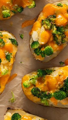 baked potatoes with broccoli and cheese on top, sitting on waxed paper