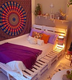 a bed made out of pallets in a room with a purple blanket on it