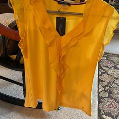 Ladies Bright Yellow Top. Size Large. 95% Polyester And 5% Spandex. No Wrinkles. Perfect For Work Or Travel! Pet Free Home And Smoke Free Home. This Will Make You Tan Pop!! Spring Stretch Top By Tommy Hilfiger, Tommy Hilfiger Stretch Top For Spring, Spring Tommy Hilfiger Stretch Top, Fitted Tommy Hilfiger V-neck Tops, Fitted Tommy Hilfiger Tops For Summer, Tommy Hilfiger Fitted V-neck Tops, Tommy Hilfiger Fitted Summer Tops, Yellow Stretch V-neck Blouse, Fitted V-neck Tommy Hilfiger Tops