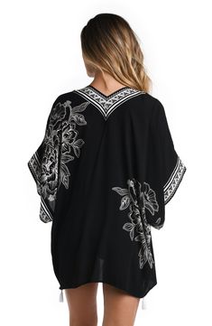 Elegance meets nature in this cover up adorned with a captivating black and white floral print, evoking a timeless sense of beauty. The juxtaposition of dark and light hues creates a harmonious blend that's both graceful and alluring. It has a breezy, square cut design, a carefree open front and playful tassels on the sleeves and hem. While it's the perfect piece to pair with your suit, this chic cover-up also makes a stylish statement when layered with a casual outfit for sea-to-shore ease. [sp Black Printed Beachwear Top, Black Beachwear Kimono For Spring, Black Summer Top With Kimono Sleeves, Black Floral Print Beachwear Tops, Black Kimono Sleeves Top For Spring, Black Kimono For Beachwear, Black V-neck Cover-up For Spring, Black Kimono For Beach Cover-up In Spring, Black Spring Kimono For Beach Cover-up