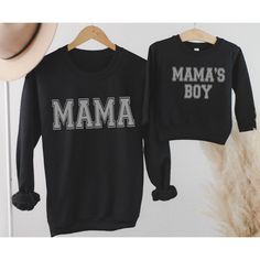 The Cutest matching Mommy and Son shirts.  Mama and Mama's Boy t-shirt or sweatshirt in 3 Colors. Soft and Comfy our Unisex Sized Sweatshirts are sure to be a favorite.   TO PLACE YOUR ORDER: 1. Select your size/style and color from the drop down menus 2. Enter Mama and Mama's Boy Color Preference in Personalization Section: Black, White, Charcoal Gray 3. Click Add to Cart, then go back and repeat for each shirt. Please see images for sizing details. Please measure your current sweatshirts that Black Long Sleeve Sweatshirt With Name Print, Family Matching Graphic Print Sweatshirt, Cotton Top With Name Print For Winter, Winter Cotton Top With Name Print, Family Matching Crew Neck Sweatshirt With Graphic Print, Black Family Matching Tops For Winter, Graphic Print Long Sleeve Top, Family Matching Black Sweatshirt For Winter, Matching Cotton Sweatshirt For Fall