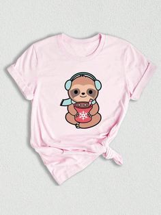 a pink shirt with a cartoon bear wearing headphones and holding a cup in her hands