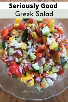 a salad with cucumbers, tomatoes and other vegetables in it on a glass plate