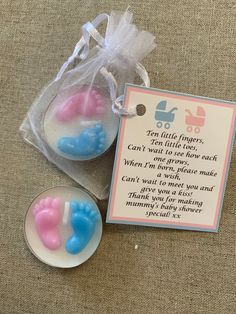 two baby feet soaps sitting on top of a table next to a tag with the words ten little fingers, can't wait for each other