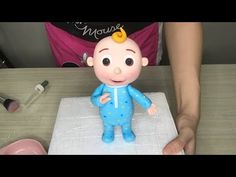 a cake with a baby doll on top of it