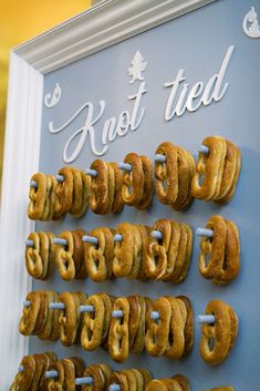 donuts are lined up in rows on a wall with the words knot tied above them