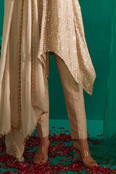 Ivory gold asymmetric kurta with all over mirror, pearl, thread embroidery. Paired with a straight pant and dupatta with sequin work. - Aza Fashions Elegant Traditional Drape Pants For Eid, Luxury V-neck Kurta With Mirror Work, Elegant Pants With Traditional Drape For Parties, Elegant Pants With Traditional Drape For Weddings, Elegant Party Pants With Traditional Drape, Elegant Festive Pants For Eid, Elegant Pants With Dabka For Festive Occasions, Elegant Festive Pants With Traditional Drape, Elegant Festive Pants With Sheer Dupatta