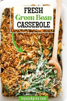 fresh green bean casserole in a white dish with a wooden spoon on the side