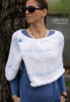 This warm poncho is hand knitted by me of thick woolen blend yarn (30% wool and 70% acrylic) in white  with light blue threads and decorative button close to the neckline. It is so soft, warm and cozy that you`ll really love it! This hand made garment is perfect for the autumn chilly mornings and evenings and for the cold winter days. One size Hand wash only, please! READY TO SHIP Thank you for visiting my Etsy shop: https://www.etsy.com/shop/GeryYapHandKnits4 Hand Knitted White Poncho For Winter, Hand Knitted White One-size Sweater, Hand Knitted White Sweater One Size, White Hand Knitted One Size Sweater, White Hand Knitted Sweater One Size, Handmade White Sweater, White Hand-knitted Winter Shawl, White Hand Knitted Winter Shawl, White Hand Knitted Shawl For Winter