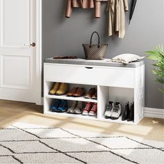 a white shoe rack with shoes and purses on it