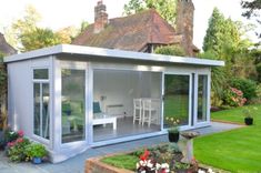 a garden room with sliding glass doors on the outside