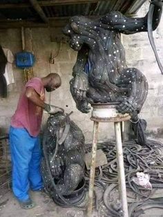 a man is working on an animal statue