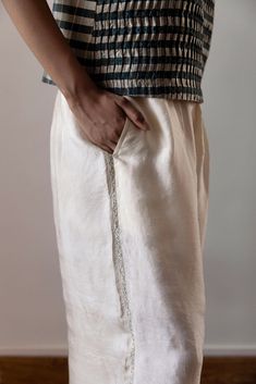 Experience the luxurious comfort of our Anghedi silk pants. Made with butter coloured silk, they offer a flowy and romantic touch to any outfit. The beautiful Tagai embroidery on the side seams adds a unique and elegant touch. Elevate your wardrobe with these stylish and comfortable pants. Traditional Silk Pants For Summer, Elegant Embroidered Silk Bottoms, Elegant Wide-leg Bottoms With Chikankari Embroidery, Traditional Silk Straight Pants, Elegant Chikankari Embroidered Bottoms For Summer, Elegant White Chikankari Embroidered Bottoms, Elegant White Chikankari Embroidery Bottoms, Elegant Summer Bottoms With Chikankari Embroidery, Elegant White Bottoms With Chikankari Embroidery