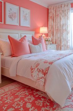 a bedroom decorated in coral and white with pink accents on the walls, along with floral curtains