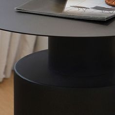 a laptop on top of a round table