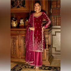 Beautiful Wine Straight Kurta With Sequin, Thread, Zari And Stone Embroidery. Paired With An Embroidered Flared Palazzo And Dupatta. No Of Components: 3 Components: Dupatta, Kurta, Palazzo Pattern: Embroidered Type Of Work: Sequin, Stone, Thread, Zari Neckline: Leaf Sleeve Type: Long Fabric: Dupatta: Net, Kurta: Velvet, Palazzo: Silk Color: Wine Other Details: Attached Lining Occasion: Sangeet, Reception Care: Dry Clean Only. Used Once To Take Pictures. Smoke Free Home Red Embroidered Salwar Kameez For Formal Occasions, Formal Red Salwar Kameez With Intricate Embroidery, Red Sharara With Intricate Embroidery For Formal Occasions, Red Sharara With Intricate Embroidery For Formal Events, Formal Red Embroidered Salwar Kameez, Elegant Red Salwar Kameez, Red Formal Sharara With Intricate Embroidery, Formal Red Sharara With Intricate Embroidery, Elegant Velvet Salwar Kameez With Intricate Embroidery