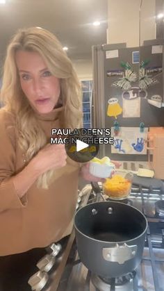 a woman standing in front of a frying pan with food on top of it