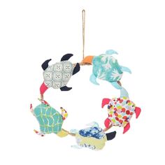 an ornament with sea animals hanging from it's sides