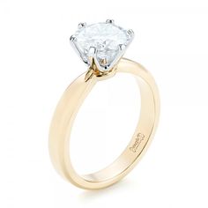 a yellow gold engagement ring with an oval cut diamond