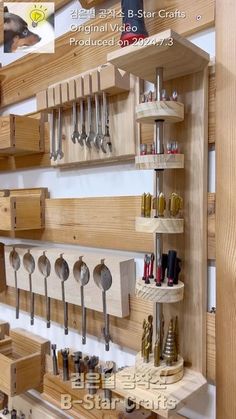 the wall is made up of wooden shelves with spoons and other tools on them