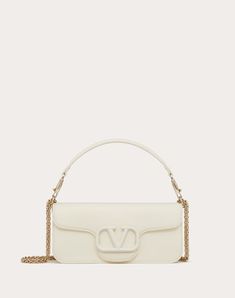 Valentino Garavani Locò shoulder bag in calfskin leather with enamel tone-on-tone VLogo Signature detail. Equipped with both a detachable sliding chain strap and a detachable handle, this accessory can be worn as a crossbody/shoulder bag or carried as a handbag. - Platinum-finish hardware - Magnetic closure with logo - Removable leather handle - Shoulder strap with removable sliding chain - Nappa leather lining. Interior: one slip pocket Shoulder strap drop length: min. 26 cm / 10.2 in. to max. Valentino Bags, Bag For Women, Nappa Leather, Magnetic Closure, Leather Handle, Crossbody Shoulder Bag, Valentino Garavani, Chain Strap, Shoulder Bag Women