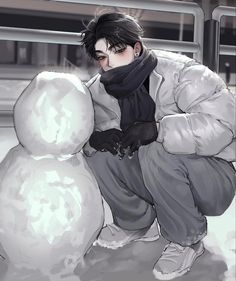 a man kneeling down next to a snowman in front of a metal fence and building