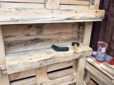 a wooden bench made out of pallet wood with tools on the top and bottom