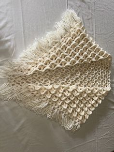 Hand crocheted shawl, white, little bucket stitched, completely homemade. Great for the cold, will keep you warm and cozy while looking stylish. No jacket needed! Length is 47 inches with a height of 30 inches and a width of 65 inches. Handmade Cream Shawl For Winter, White Crochet One-size Shawl, White Hand Knitted Shawl For Winter, White Hand-knitted Winter Shawl, Cream Hand Knitted Shawl For Winter, White Hand Knitted Winter Shawl, Winter Cream Hand Knitted Shawl, White One-size Shawl For Winter, White Bohemian Winter Shawl