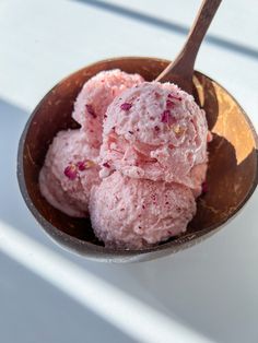 two scoops of ice cream in a wooden bowl