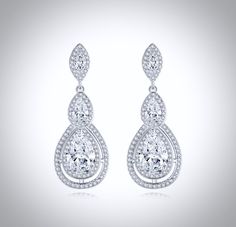 A delightfully unique pair of bridal earrings with an incredible sparkle! Adorned with flawlessly faceted cubic zirconia that capture the light in a dazzling array of sparkles, the earrings are rhodium plated for a bright finish which enhances the intricate detailing and conveys a modern take on old elegance. Overall length of the earring is 1.5" (approx. 4cm). Available in Silver, Rose Gold and Yellow Gold finishes. To make your choice select your preferred finish from the dropdown menu to add Cubic Zirconia Bridal Earrings, Silver Rose Gold, Bridal Earrings, Exquisite Design, Gold Finish, Rhodium Plated, Wedding Jewelry, Wedding Gowns, Cubic Zirconia