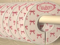 there are six plates with bows on them and the name neubom is in pink