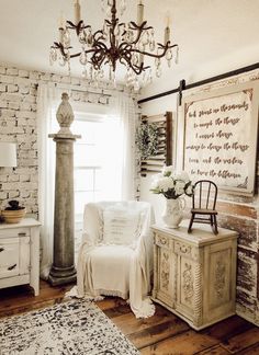 a room with white furniture and a chandelier