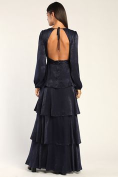 Turn heads and celebrate romance in the Lulus Tier For Love Navy Blue Satin Long Sleeve Tiered Maxi Dress! Smooth satin shapes this stunning dress that has a plunging V-neckline framed by long sleeves with elastic at the cuffs. The fitted bodice features a flirty open back with a tying accent. Banded waist falls to a tiered skirt that ends at a maxi hem. Hidden back zipper/clasp. Fit: This garment fits true to size. Length: Floor length. Size medium measures 60.25" from shoulder to hem. Bust: Gr Navy Blue Satin Dress, Maxi Dress Satin, Blue Satin Dress, Tiered Maxi Skirt, Lulu Fashion, Satin Long Sleeve, Tiered Maxi Dress, Blue Satin, Tiered Skirt