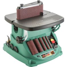 a sanding machine that is sitting on top of a table with wheels and pads