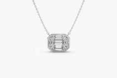 "Diamond Necklace / 14k F Color VVS Clarity 1.25Ctw Look Emerald Cut Illusion Setting Diamond Necklace / Step Cut Mosaic Diamond Pendant by Ferkos Fine jewelry This pendant has the face-up look of a 1.25ct emerald cut diamond, for a fraction of the cost! The total weight on this Pendant is 0.48ctw. Accurately custom cut, 9 step-cut baguette diamonds are matched and cut perfectly so they sit next to each other flawlessly, giving the appearance of a single diamond. The Pendant is made in White Gol Luxury 14k White Gold Jewelry With Baguette Diamonds, Diamond Solitaire Necklace With Baguette Diamonds For Anniversary, Anniversary Solitaire Necklace With Baguette Diamonds, White Cubic Zirconia Emerald-cut Diamond Necklace, Dazzling White Baguette Diamond Necklace, White Diamond Necklace With Baguette Cut Accents, White Diamond Necklace With Baguette Cut, Anniversary Baguette Diamond Solitaire Necklace, White Baguette Cut Diamond Necklace With Accents