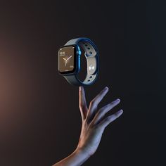 a hand holding an apple watch in the air