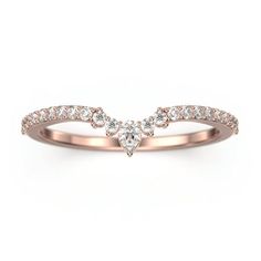 a rose gold ring with diamonds in the middle and an arrow shaped band on top