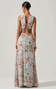 The Noya Dress features a floral print throughout. Plunging neckline leads to a cross front waist with cutout details. Ruffle maxi skirt. Lace up back. Concealed back zip closure. SIZE + FITLength: 59"Model is wearing size SModel height is 5'8"Size S:Bust 28 1/2" DETAILS + CAREDry clean onlySelf: Self 100% Polyester Lining 100% PolyesterCutout detailZipper closure فستان زهري, Ruffle Maxi Skirt, Flora Dress, Cutout Maxi Dress, Aqua Dress, Dress With Tie, Maxi Dress Green, Ruffled Maxi Dress, Daily Dress