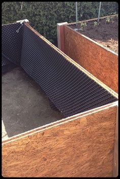 an open wooden box sitting in the middle of some dirt