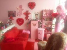 a living room filled with lots of furniture and pink walls covered in valentine's day decorations