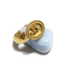 Beautiful custom gold signet ring inspired by antique ethnic style in 14k gold. The Antique style signet Ring features an Egyptian symbols of a spider, waves and sun that signify mystery, power and growth. The perfect combination of the ancient style and modernity which you will enjoy wearing, this seal ring is a great conversation starter, just slip it on to add a refreshing touch to any outfit. #signetring #goldring CLICK FOR MORE #jonjonjewel Vintage Ceremonial Signet Ring With Open Design, Vintage Ceremonial Open Signet Ring, Vintage Gold Engraved Ring, Tarnish Resistant, Vintage Gold Engraved Ring Tarnish Resistant, Vintage Gold Engraved Tarnish-resistant Ring, Vintage Tarnish Resistant Signet Ring For Promise, Vintage Tarnish-resistant Signet Ring For Promise, Vintage Gold Dome Ring With Engraving, Vintage Tarnish Resistant Signet Ring For Weddings