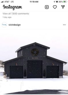 a black building with a wreath on it's roof in the middle of winter