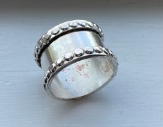 a silver ring sitting on top of a table