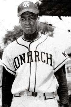 an old black and white photo of a baseball player