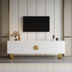 a white and gold console unit with a flat screen tv mounted on the wall behind it