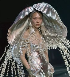 a woman in a dress made out of pearls