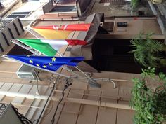 three flags are flying outside an apartment building in the european country, europe and italy