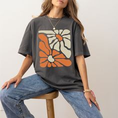 "Add an artistic touch to your wardrobe with our Henri Matisse cutouts inspired floral T-shirt. This unique and vibrant shirt is inspired by the iconic cutout art of Henri Matisse, featuring a bold and colorful floral design. We added a slight \"Washed & Worn\" aged effect in the design. Made with high-quality, soft, and cozy cotton, it's not only a fashionable statement piece but also incredibly comfortable to wear. Perfect for art lovers and fashion enthusiasts alike. Elevate your style with t Trendy Relaxed Fit Top With Abstract Print, Artsy Crew Neck Summer Shirt, Spring Tops With Abstract Print And Relaxed Fit, Artsy Spring Tops With Graphic Print, Artsy Spring Top With Graphic Print, Artsy Graphic Print Tops For Spring, Spring Cotton Tops With Abstract Print, Artistic Black Tops For Spring, Casual Cotton Tops With Abstract Print And Relaxed Fit